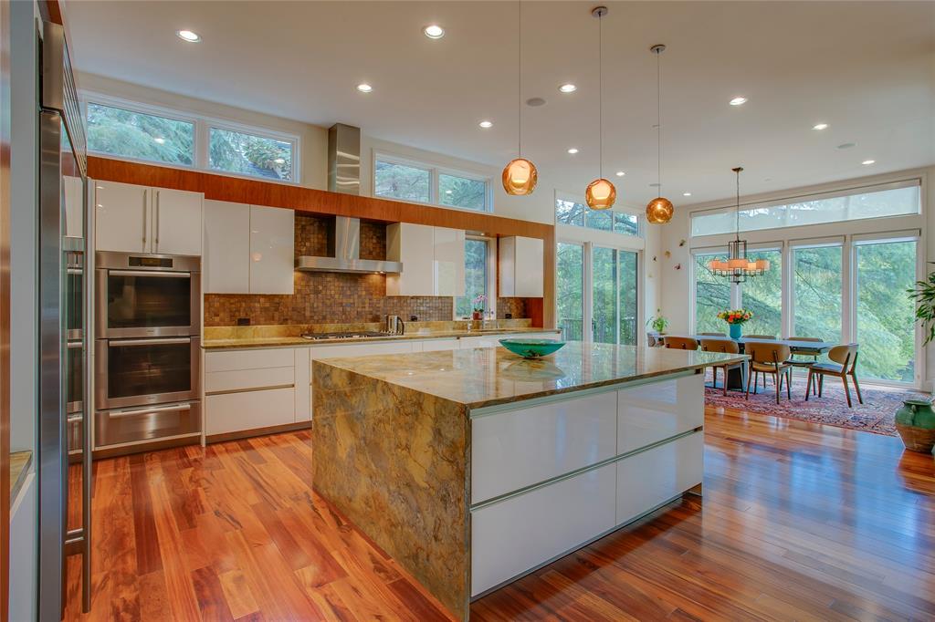 48 Ash Bluff Lane Dallas, TX 75248 - Photo 4 of 40 a kitchen with stainless steel appliances granite countertop a lot of counter space and wooden floors
