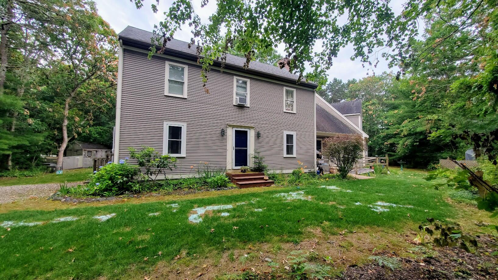 185 Monhegan Road East Falmouth, MA 02536 - Photo 1 of 23 a front view of a house with a yard