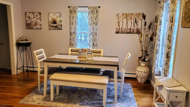 a view of a workspace with furniture and wooden floor