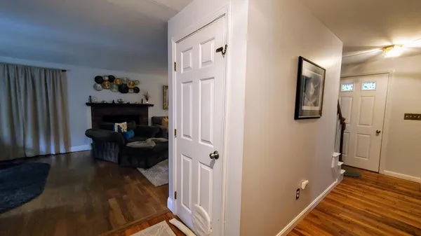 a view of a livingroom with wooden floor and furniture