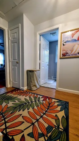 a bedroom with a bed and painting on the wall