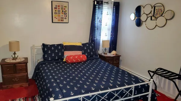 a bedroom with bed and wooden floor