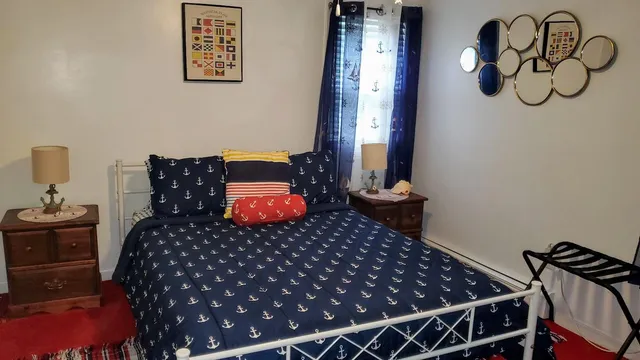 a bedroom with bed and wooden floor