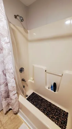 a bathroom with a bathtub and shower