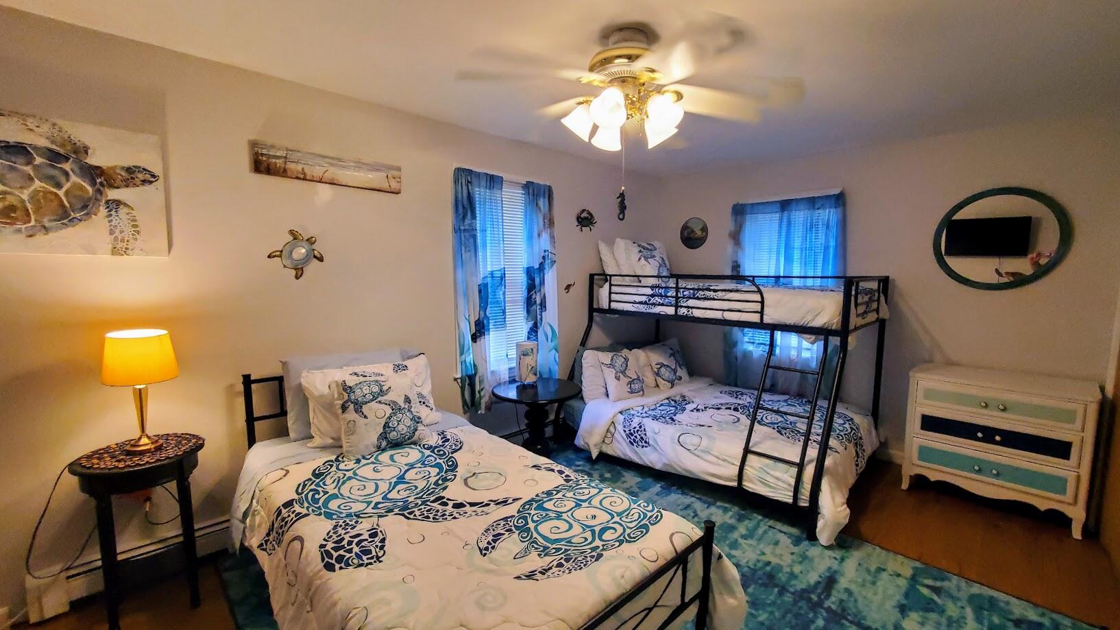 185 Monhegan Road East Falmouth, MA 02536 - Photo 20 of 23 a bedroom with a bed a chandelier and dresser