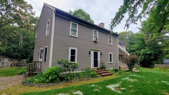 a front view of a house with a garden