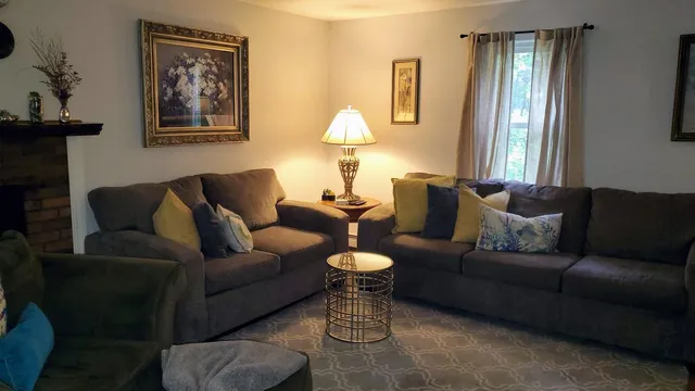 a living room with furniture and a lamp