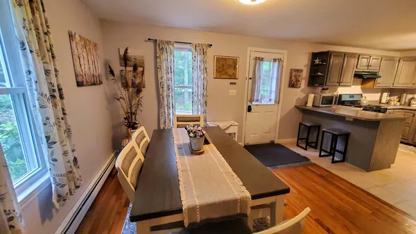 a room with furniture pool table wooden floor and windows