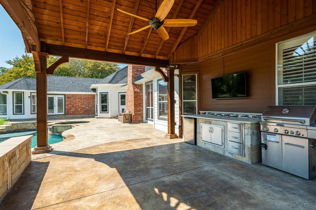 1380 Meandro Ria Lane Fairview, TX 75069 - Photo 13 of 14 a kitchen with stainless steel appliances kitchen island granite countertop a stove a sink and a microwave