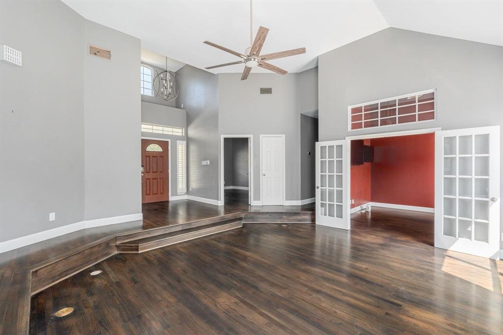 1380 Meandro Ria Lane Fairview, TX 75069 - Photo 3 of 14 a view of an empty room with a window and wooden floor