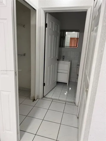 a view of a bathroom with mirror and window