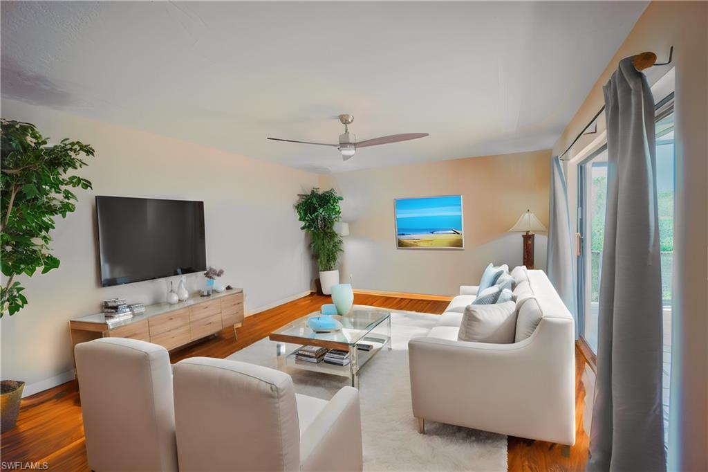 200 Marseille Drive, Unit 12A Naples, FL 34112 - Photo 12 of 36 a living room with furniture and a flat screen tv