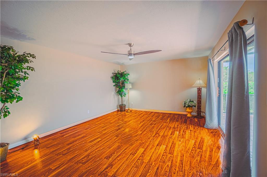 200 Marseille Drive, Unit 12A Naples, FL 34112 - Photo 13 of 36 a bedroom with a bed and a potted plant