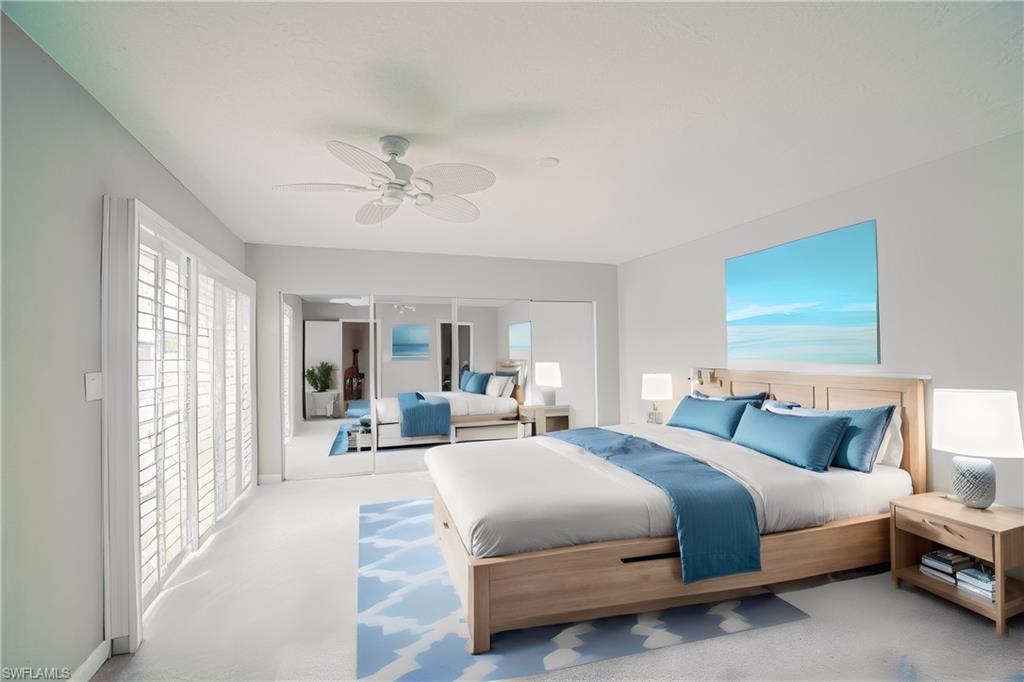 200 Marseille Drive, Unit 12A Naples, FL 34112 - Photo 16 of 36 a bedroom with a bed couch and large window