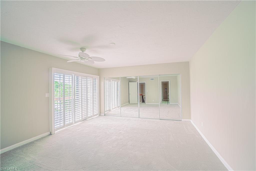200 Marseille Drive, Unit 12A Naples, FL 34112 - Photo 18 of 36 an empty room with windows