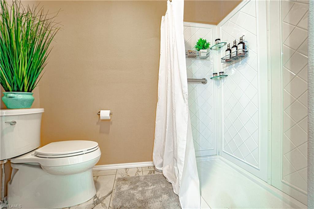 200 Marseille Drive, Unit 12A Naples, FL 34112 - Photo 20 of 36 a bathroom with a toilet and a shower
