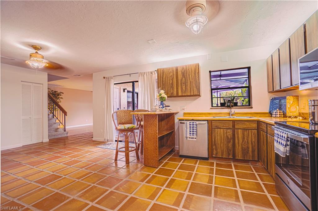 200 Marseille Drive, Unit 12A Naples, FL 34112 - Photo 2 of 36 a kitchen with a cabinets a sink and a stove top oven