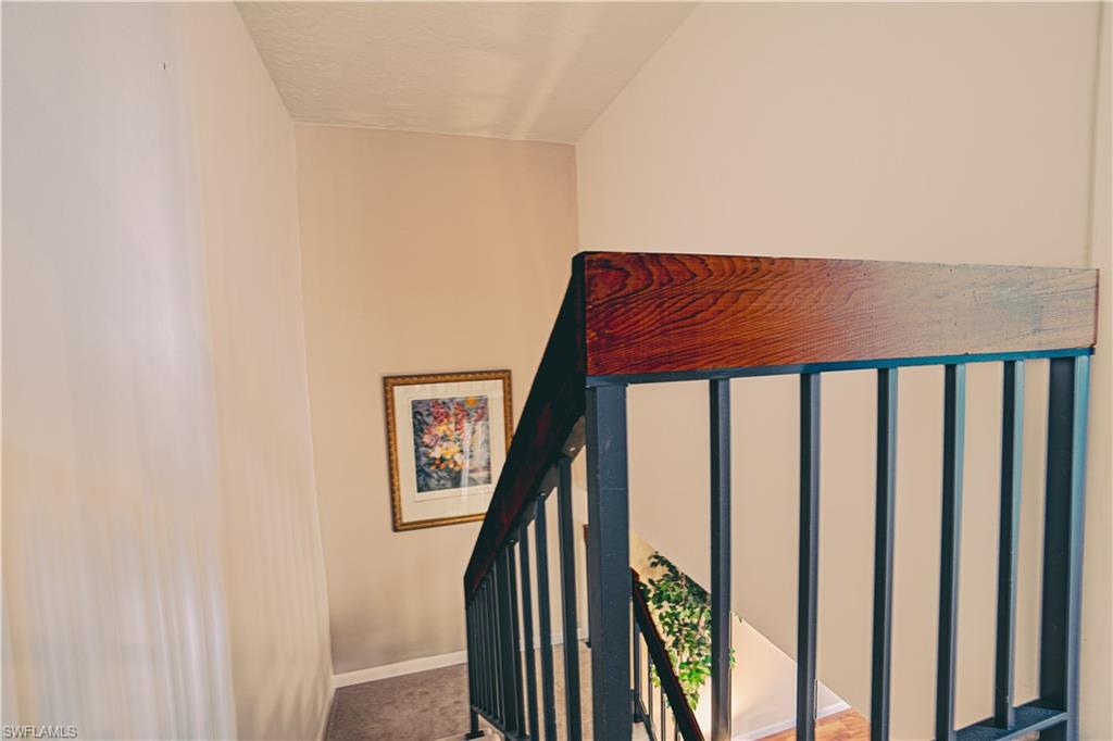 200 Marseille Drive, Unit 12A Naples, FL 34112 - Photo 30 of 36 a view of staircase with railing and white walls