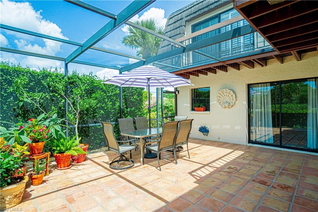 200 Marseille Drive, Unit 12A Naples, FL 34112 - Photo 3 of 36 a view of backyard with outdoor seating and plants