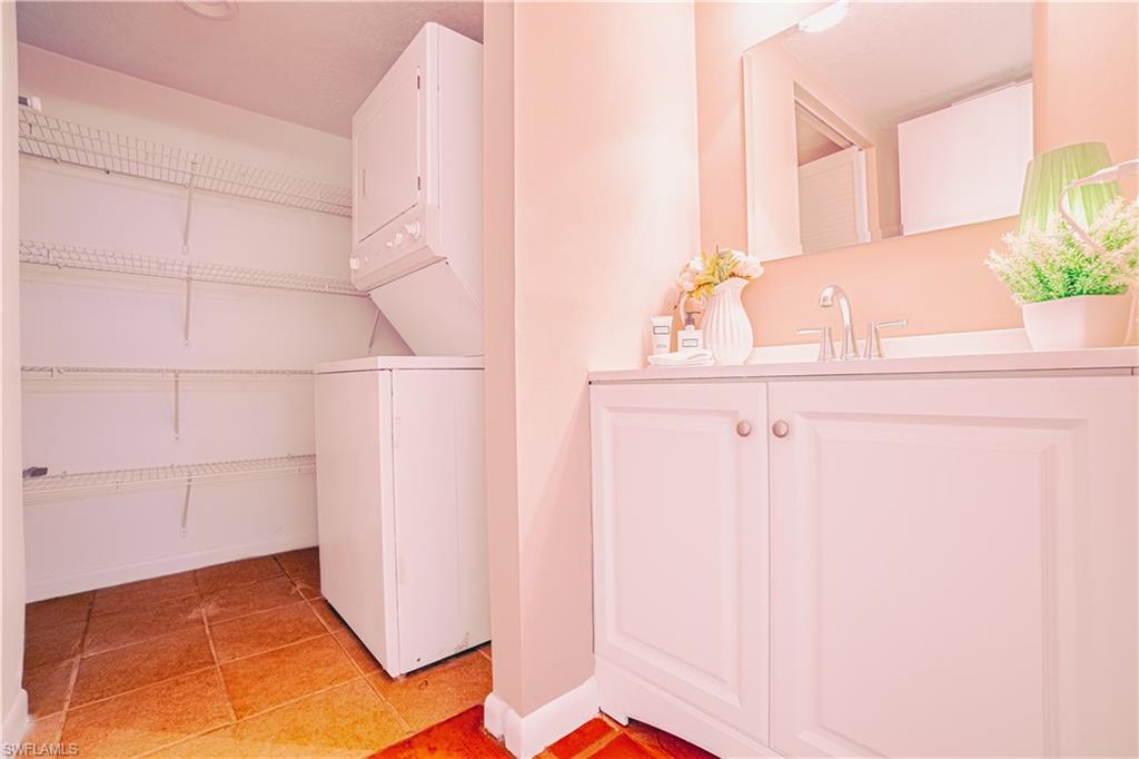 200 Marseille Drive, Unit 12A Naples, FL 34112 - Photo 31 of 36 a bathroom with a sink and a mirror