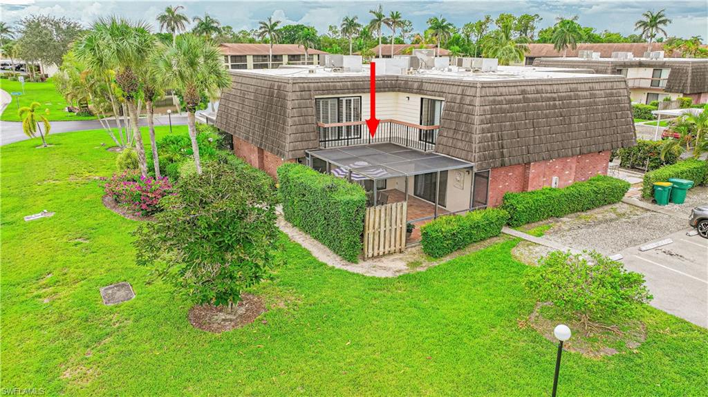 200 Marseille Drive, Unit 12A Naples, FL 34112 - Photo 35 of 36 a view of a house with a yard and potted plants