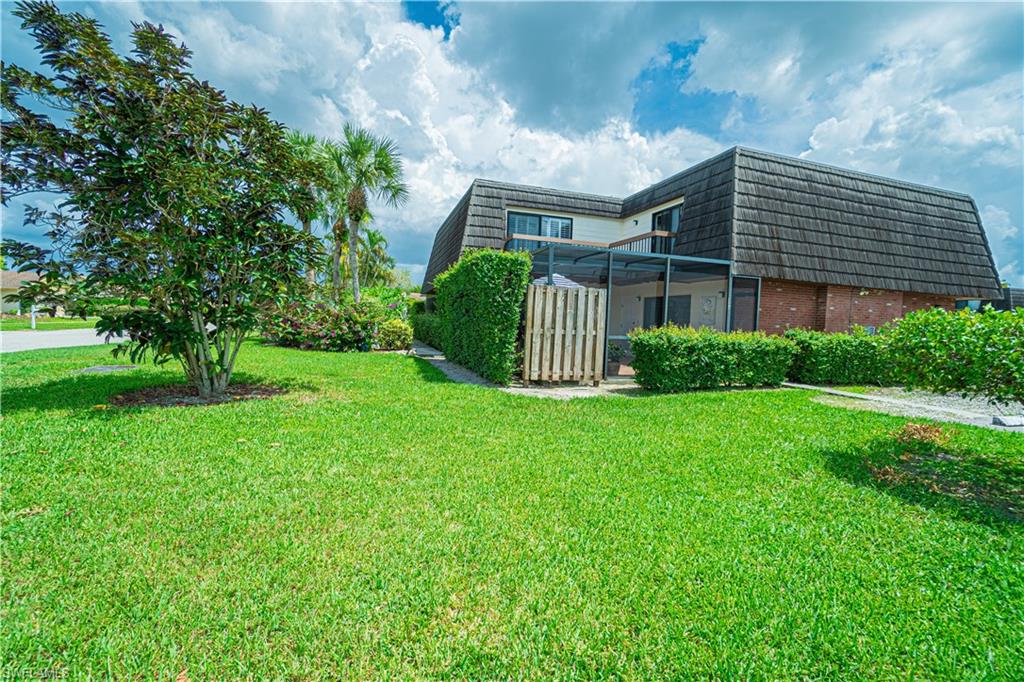 200 Marseille Drive, Unit 12A Naples, FL 34112 - Photo 5 of 36 a front view of a house with garden
