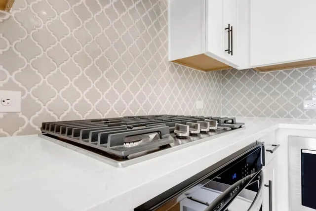a view of a livingroom with wooden floor and a ceiling fan