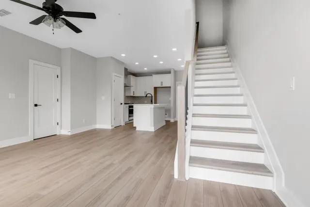 a view of a kitchen with wooden floor and electronic appliances