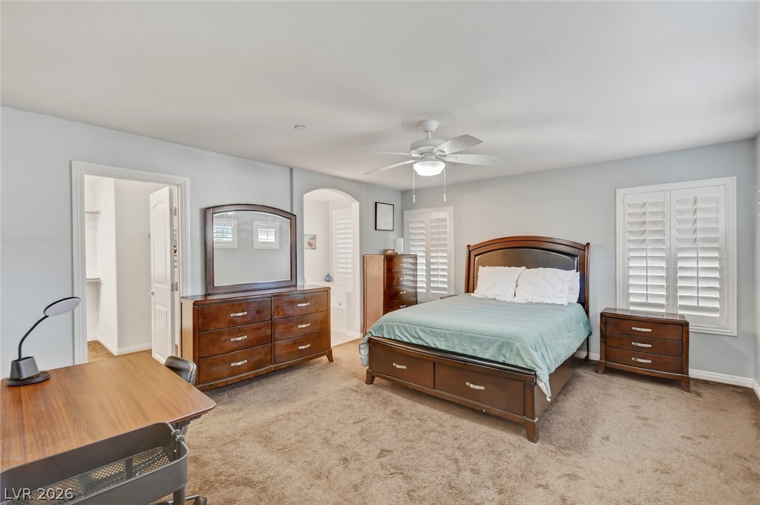 48 Jasmine Point Street Henderson, NV 89074 - Photo 36 of 62 A well-lit bedroom features plush carpeting and a convenient walk-in closet.