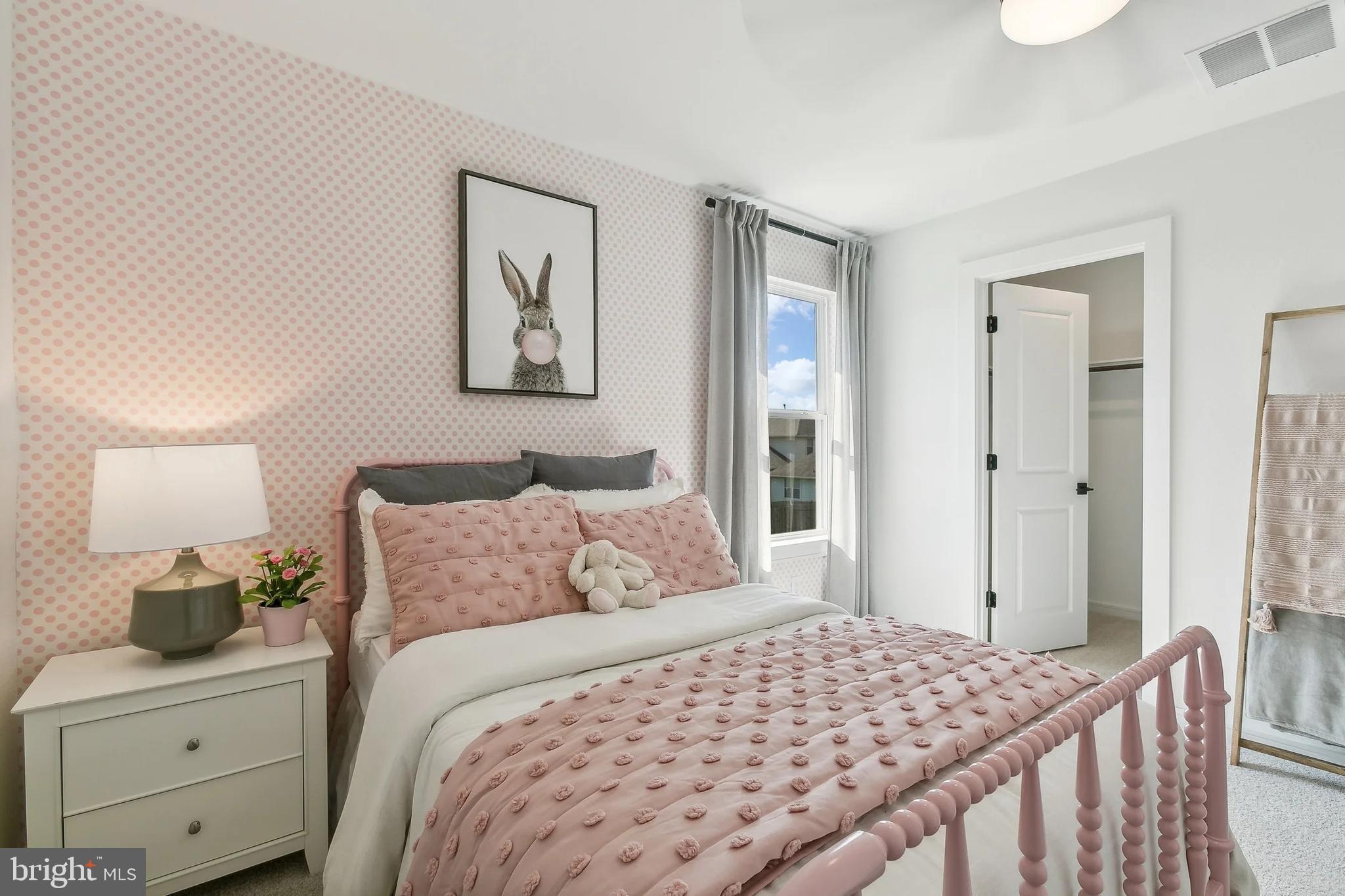 437 Gerry Street Ranson, WV 25438 - Photo 21 of 29 a bedroom with a bed and painting on the wall