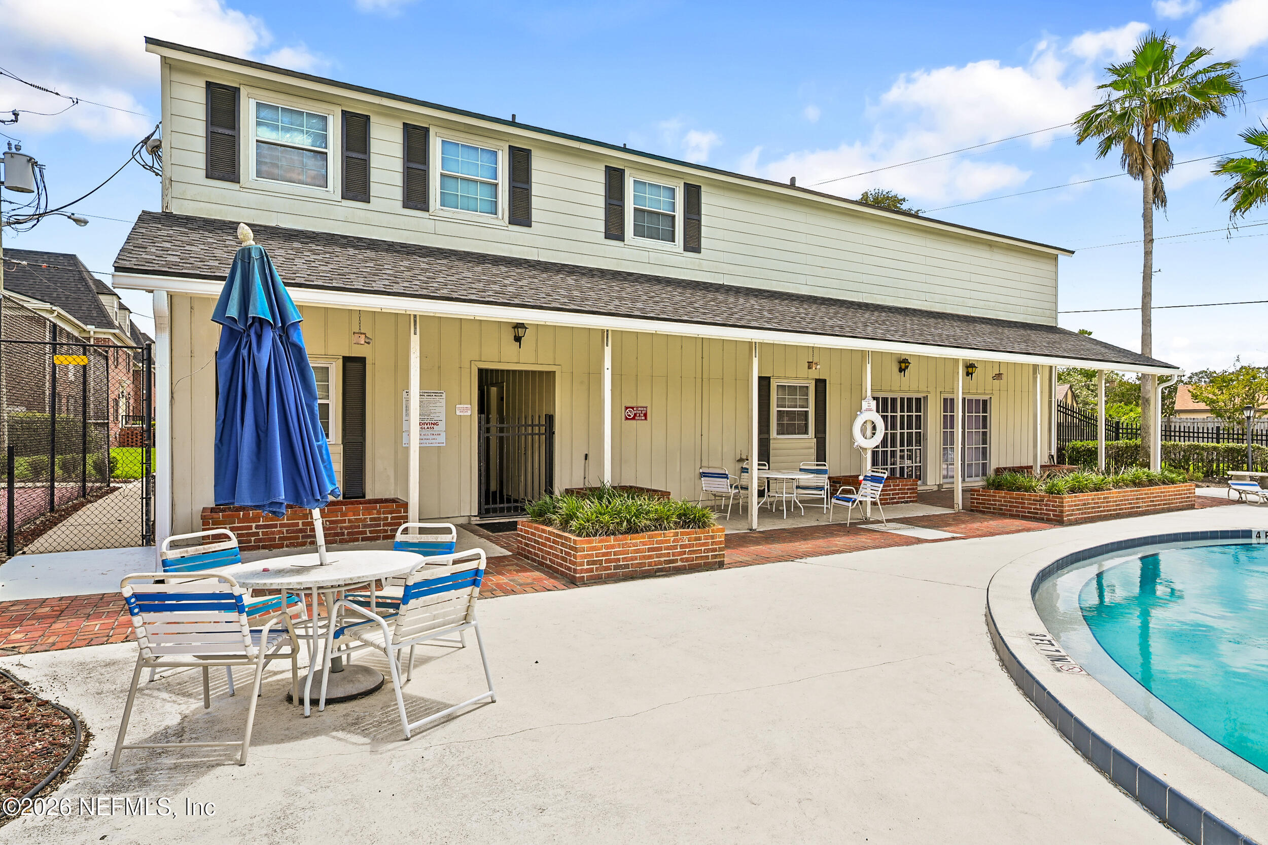 4915 Baymeadows Road, Unit 6G Jacksonville, FL 32217 - Photo 38 of 44 a view of a patio with couches table and chairs under an umbrella