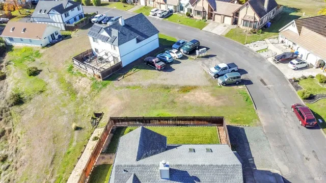 an aerial view of beach and residential houses with outdoor space