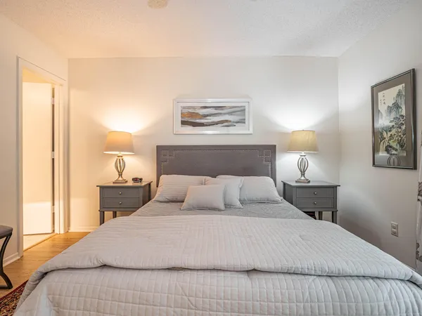 a bedroom with a bed and a chandelier