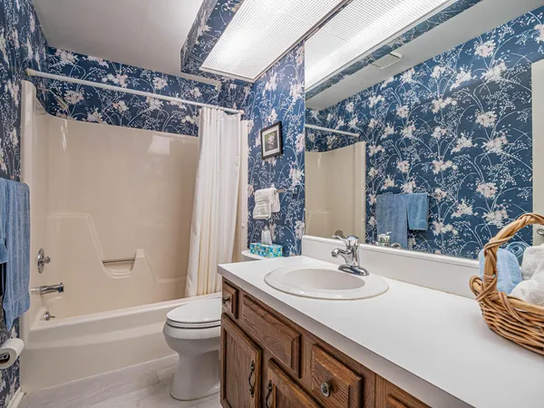 a bedroom with a bed and a night stand