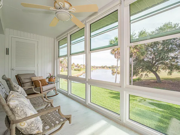a living room with furniture and a floor to ceiling window