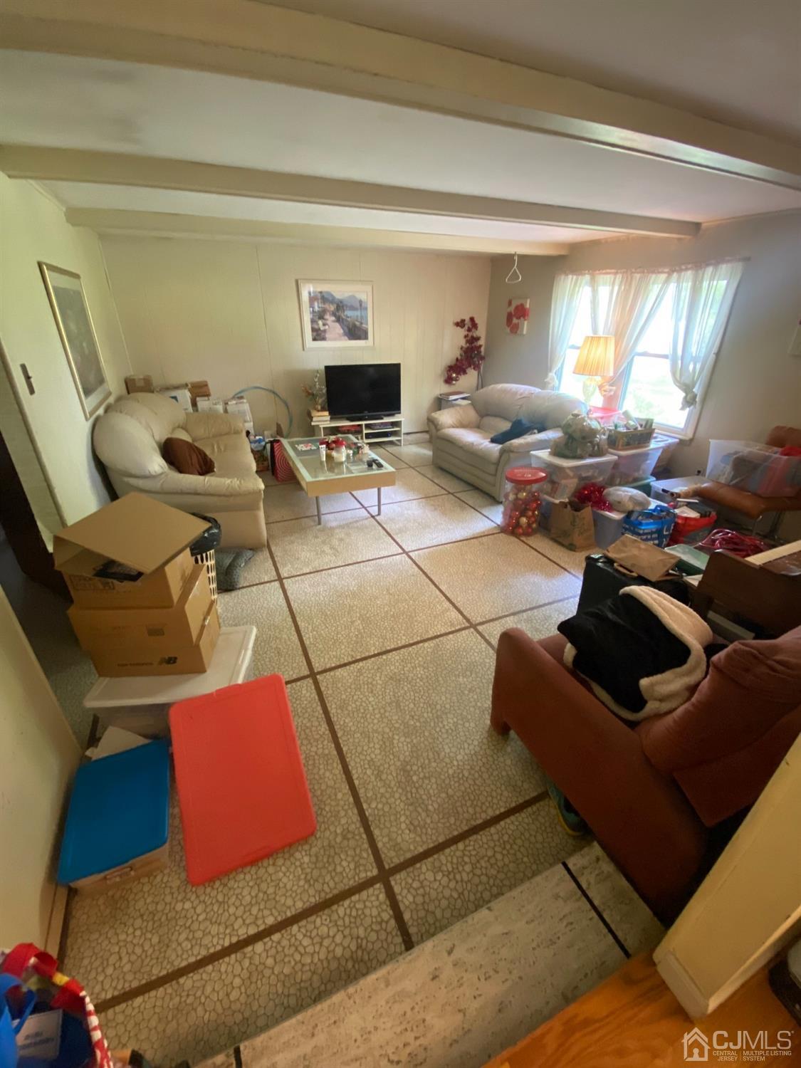 115 Sandringham Road Cherry Hill, NJ 08003 - Photo 4 of 6 a living room with furniture and a flat screen tv