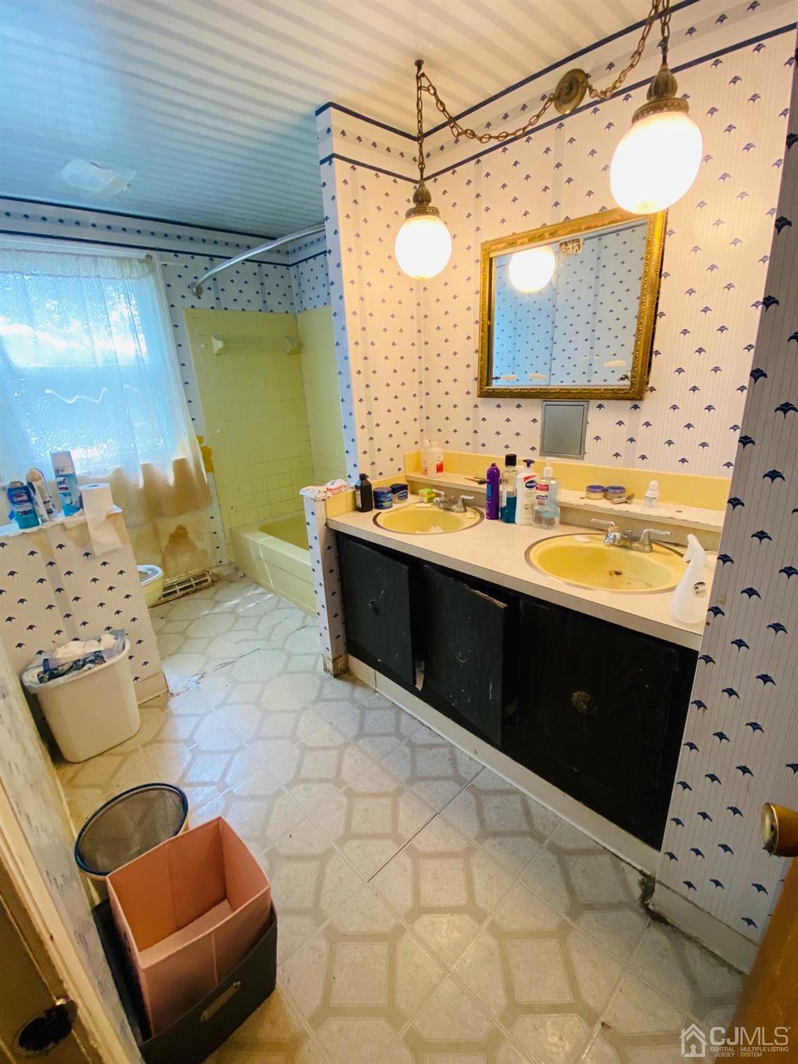 115 Sandringham Road Cherry Hill, NJ 08003 - Photo 5 of 6 a bathroom with a sink vanity and a mirror