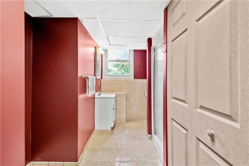 3406 McRoberts Road Pittsburgh, PA 15234 - Photo 16 of 19 a bathroom with a granite countertop sink and a mirror