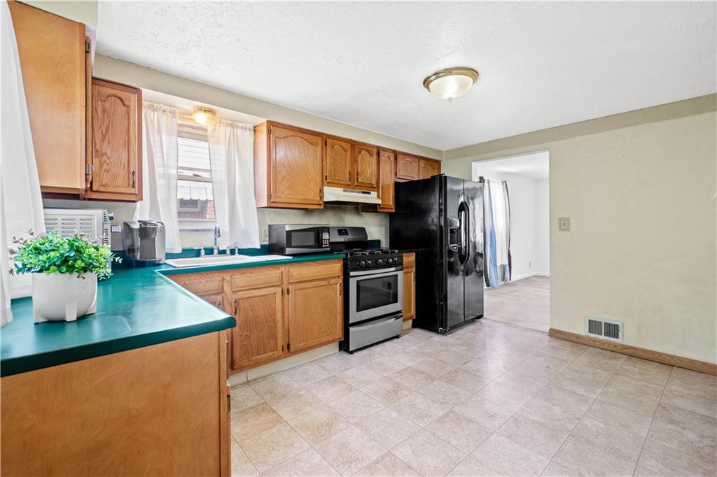 3406 McRoberts Road Pittsburgh, PA 15234 - Photo 6 of 19 a kitchen with a refrigerator and a sink