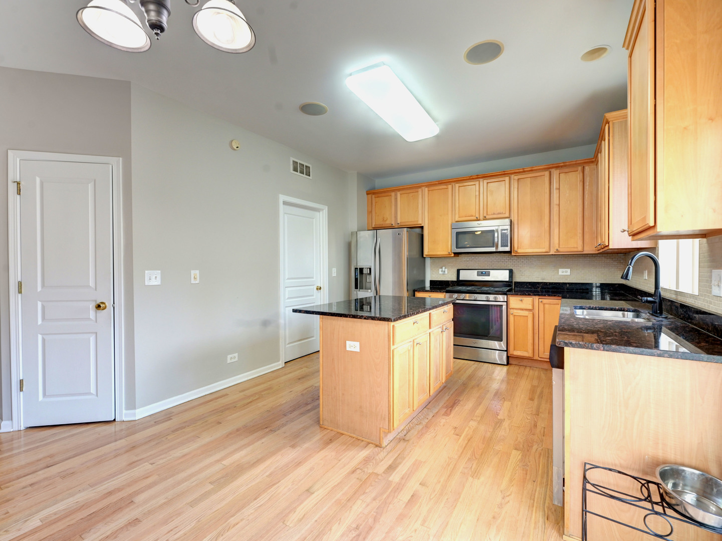 6 Forsythia Court Bolingbrook, IL 60490 - Photo 12 of 28 a kitchen with granite countertop a refrigerator stove top oven and sink