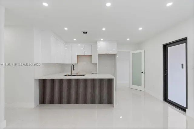 a kitchen with kitchen island sink stainless steel appliances and cabinets