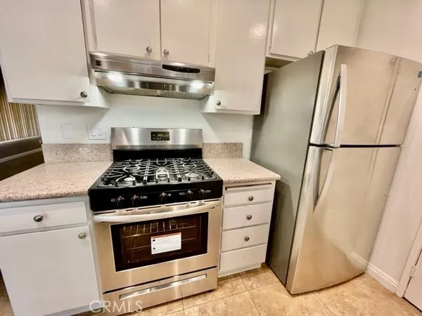 a stove top oven sitting inside of a kitchen