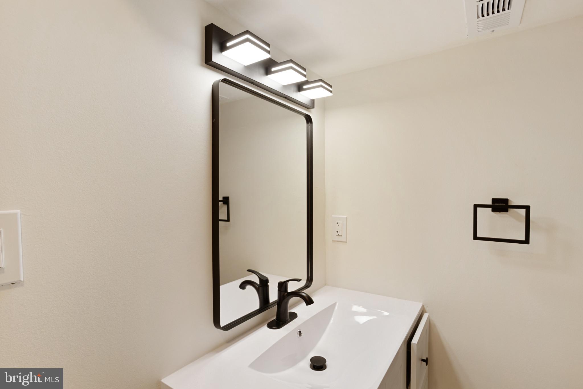 1817 Hanford Road Rosedale, MD 21237 - Photo 12 of 32 a bathroom with a sink and mirror