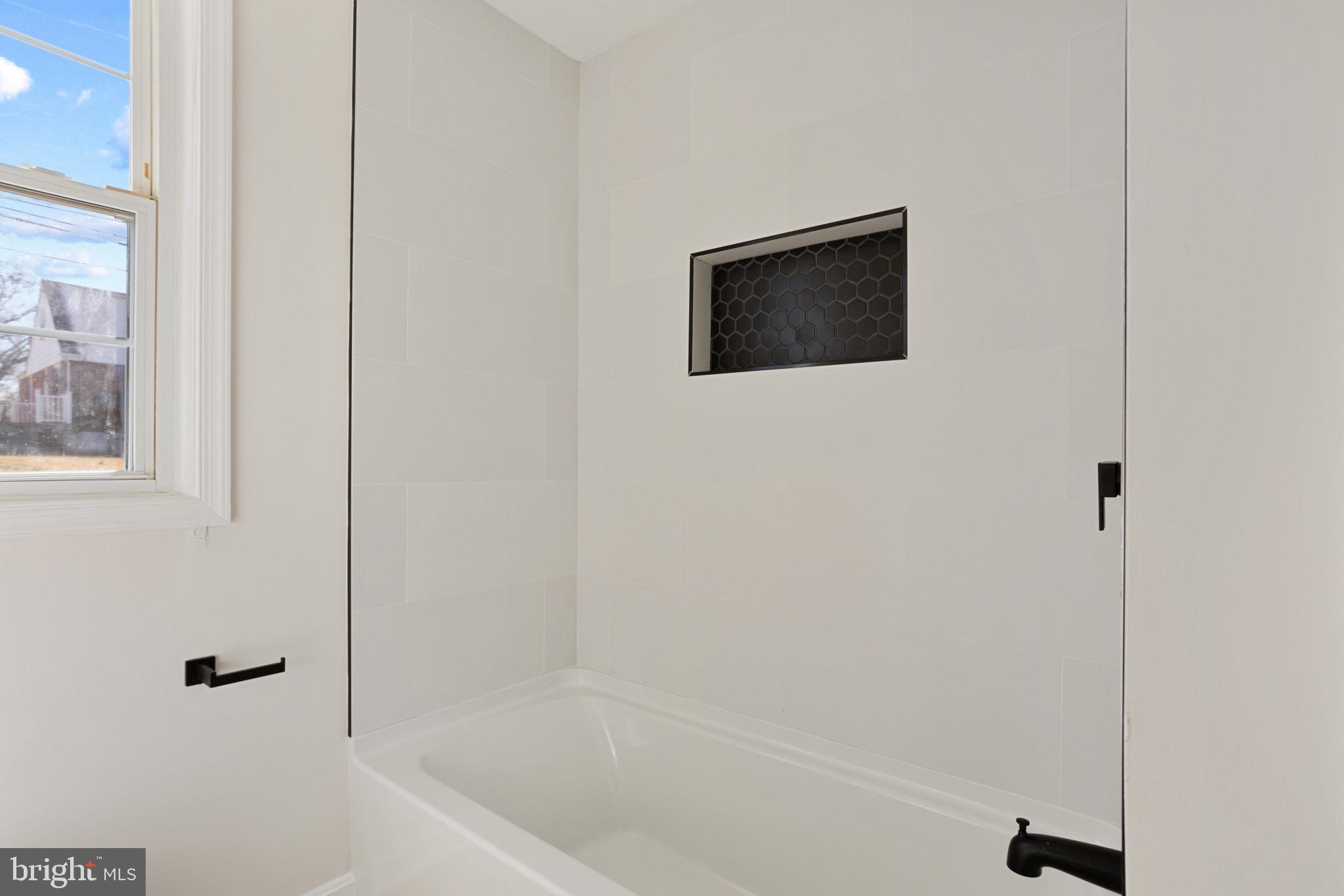 1817 Hanford Road Rosedale, MD 21237 - Photo 10 of 32 a bathroom with a bathtub and a shower