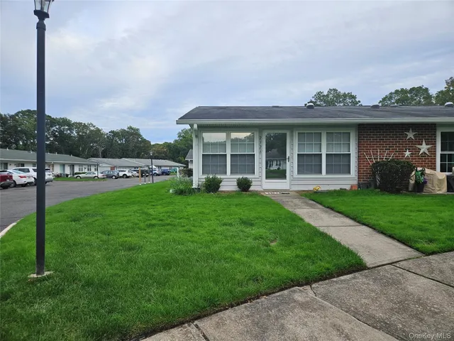a view of a house with a yard and plants