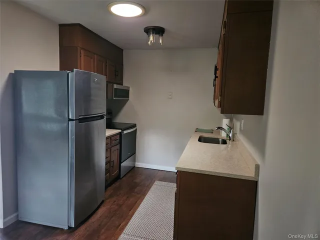 a kitchen with a refrigerator and a sink