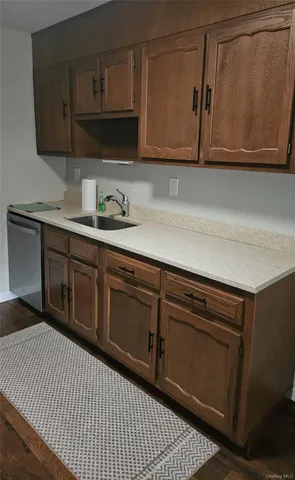 a kitchen with stainless steel appliances granite countertop a sink a stove and cabinets