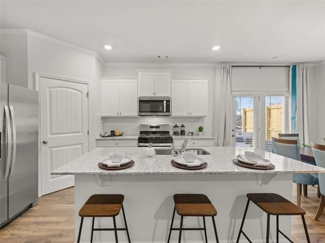 a kitchen with a table chairs stove and microwave