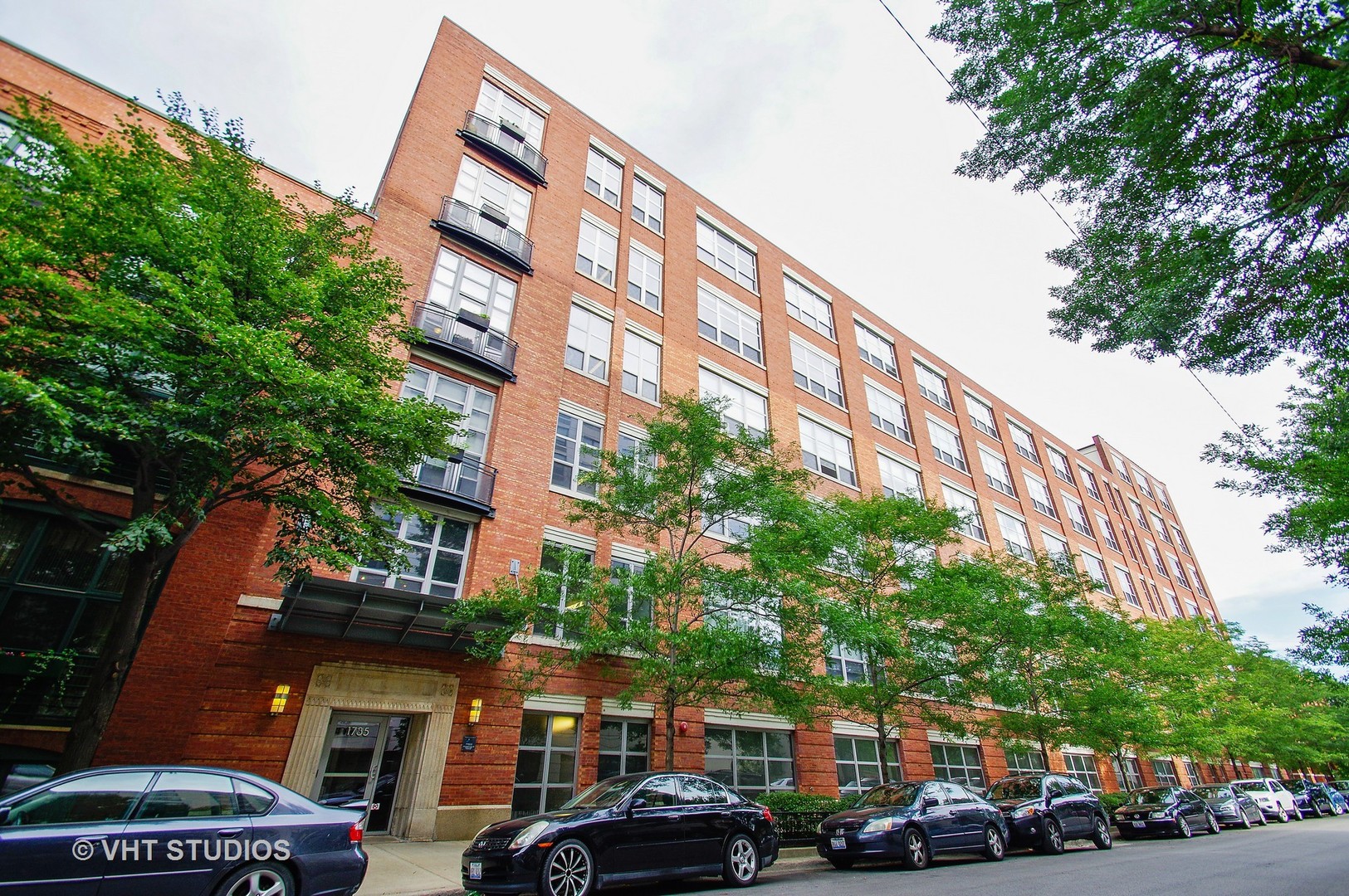 a couple of cars parked in front of building