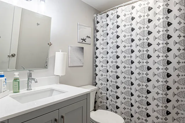 a white toilet sitting next to a bathroom sink